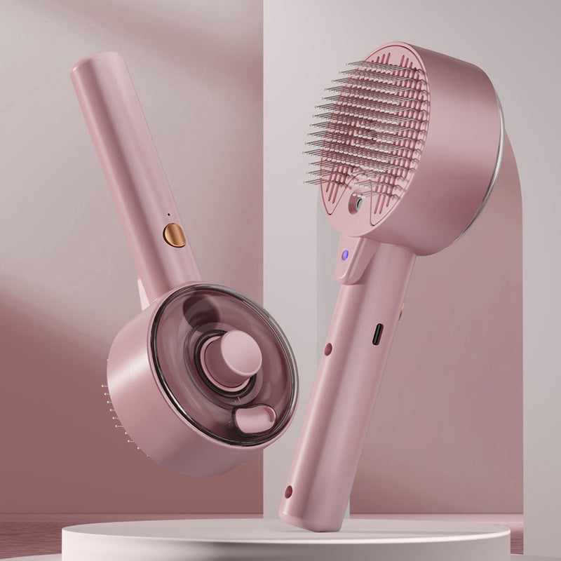 Pink handheld hair care device with brush and nozzle on a light pink background