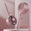 Pink handheld hair dryer with brush attachment on a light pink background
